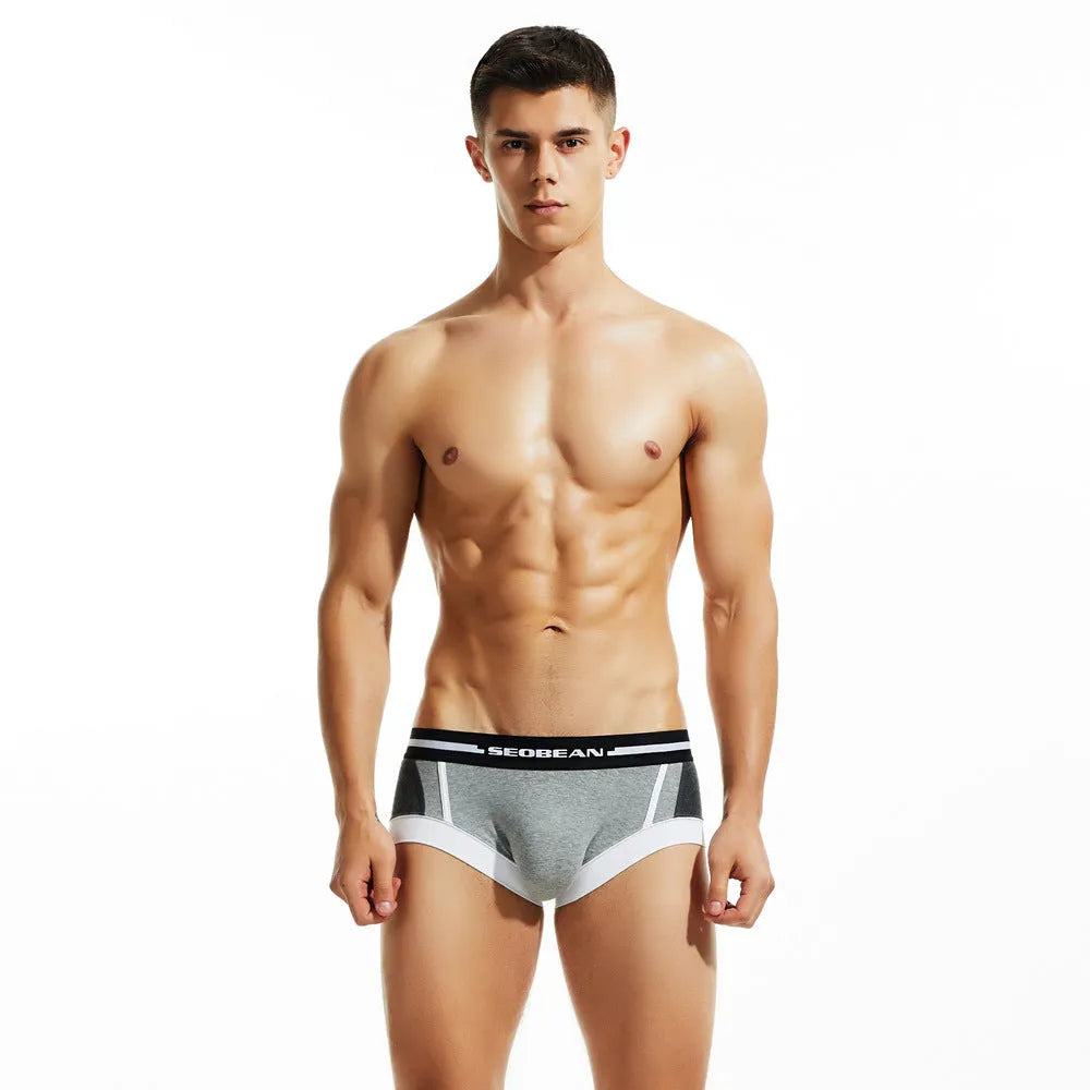 Men's cotton boxers in low waist design with hip-lifting function in red, dark blue, or light grey