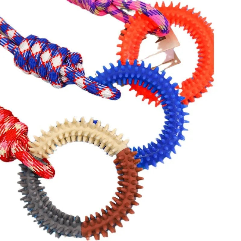 Blue braided rope dog chew toy with knotted ends on a wooden floor