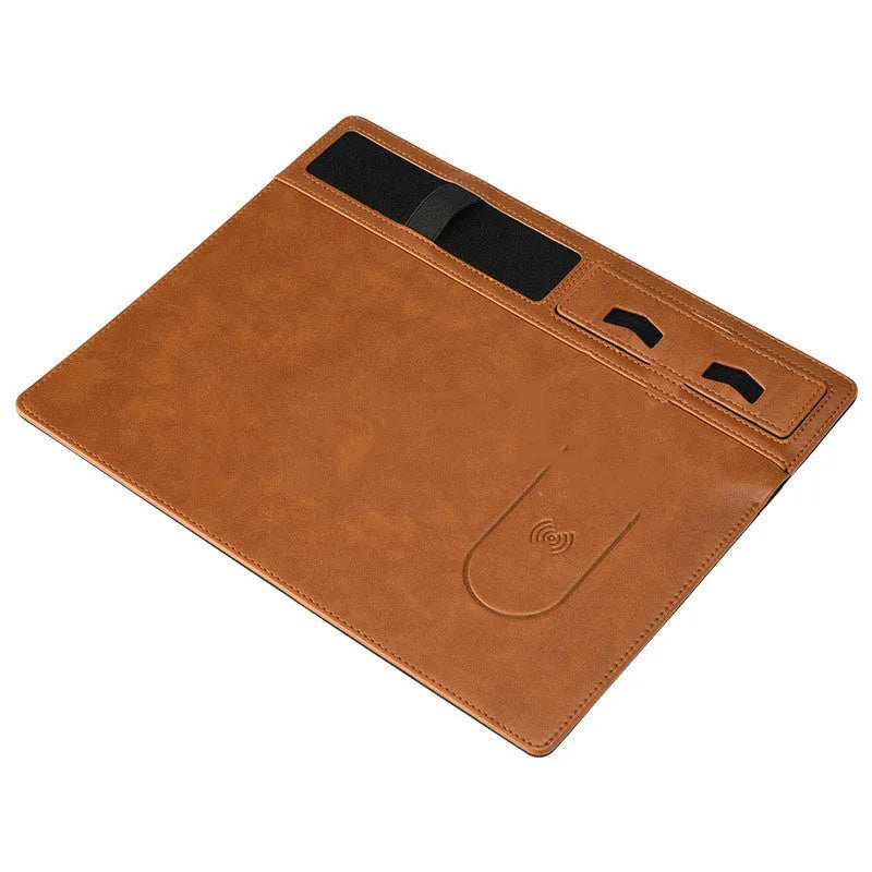 Pink wireless charging mouse pad with phone holder on a wooden desk