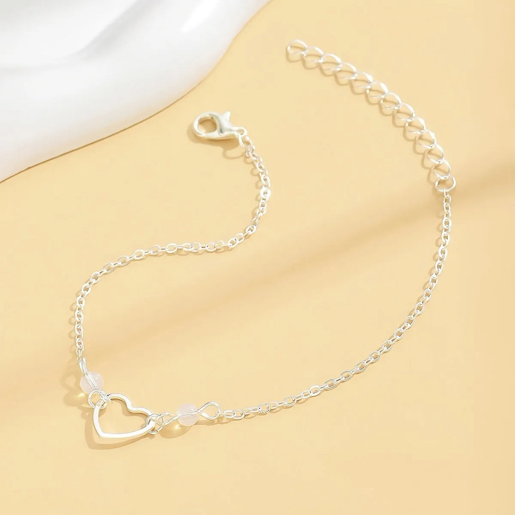 Adjustable women's anklet with heart-shaped pendant in gold and silver alloy metal