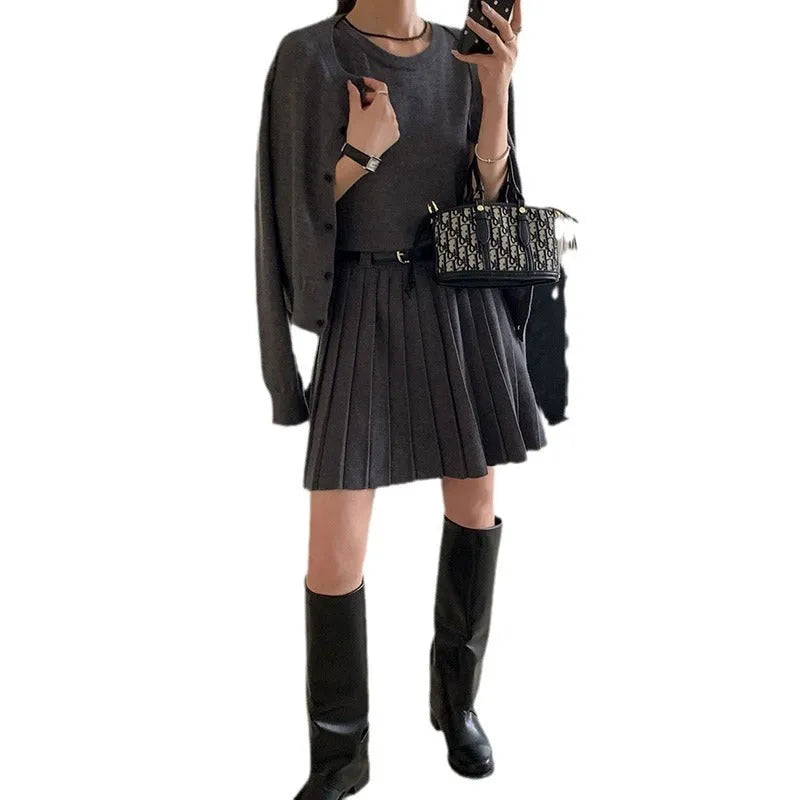 Women's grey knitted national style two-piece set with cardigan, pleated vest skirt, and belt.