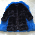 Women's thick black artificial fur coat with regular sleeves on a hanger.