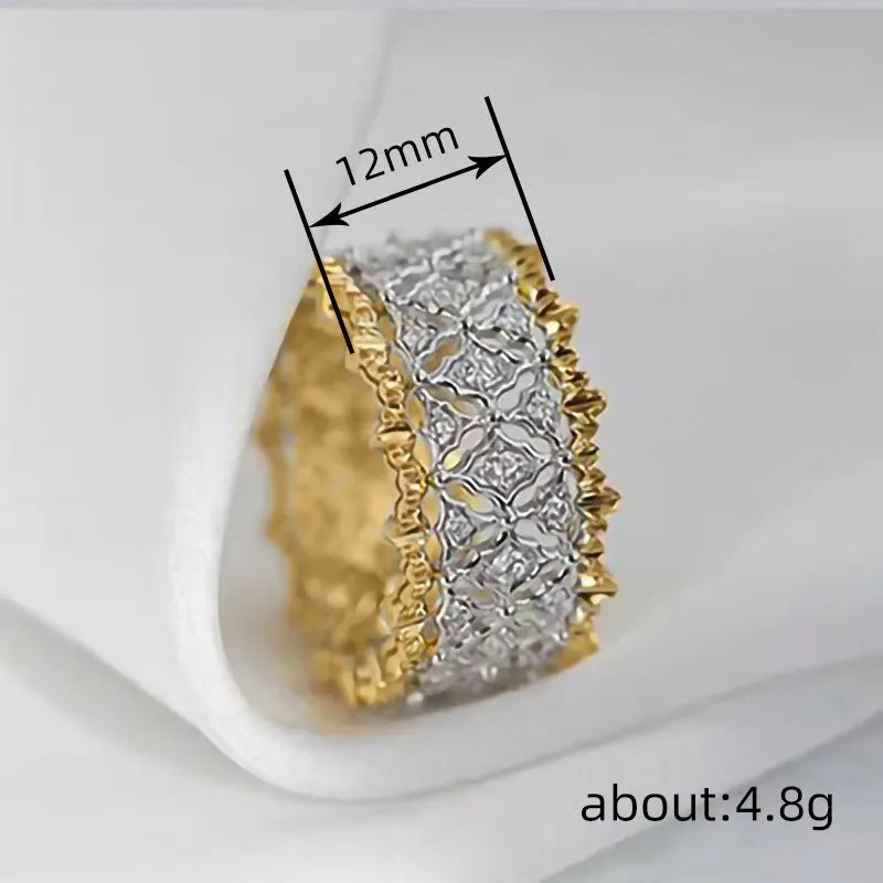 Geometric two-tone gold zircon fashion ring on a white background, showing its angular shape and round details.