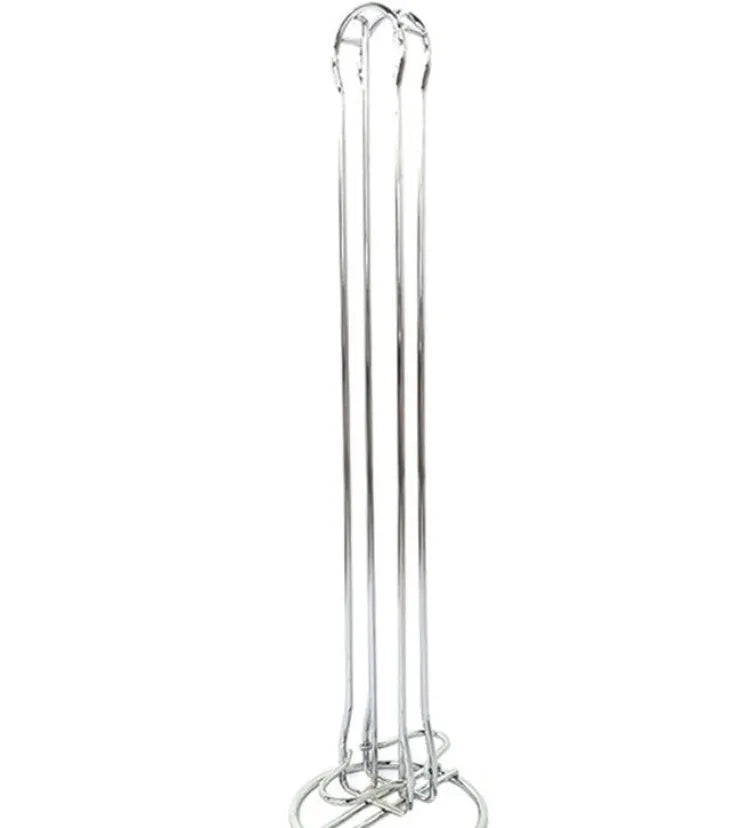 Black wrought iron coffee capsule storage rack holding pods on open shelves.