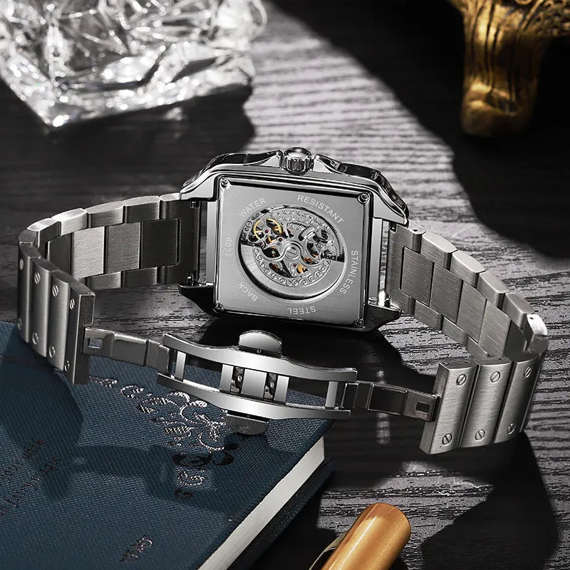 Men's square automatic watch with diamond-studded case on a black stainless steel bracelet.