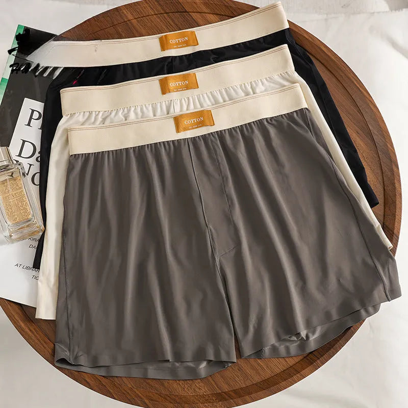 Pack of three men's solid colour loose fit nylon ice silk underwear in mid-waist style.