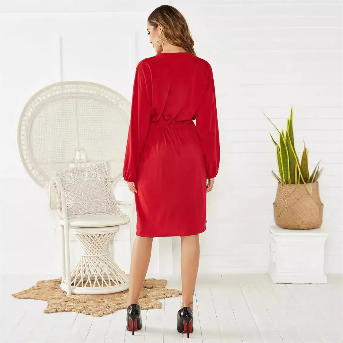 Women's black A-line midi dress with long sleeves, elastic cuffs, and a cinched belt.