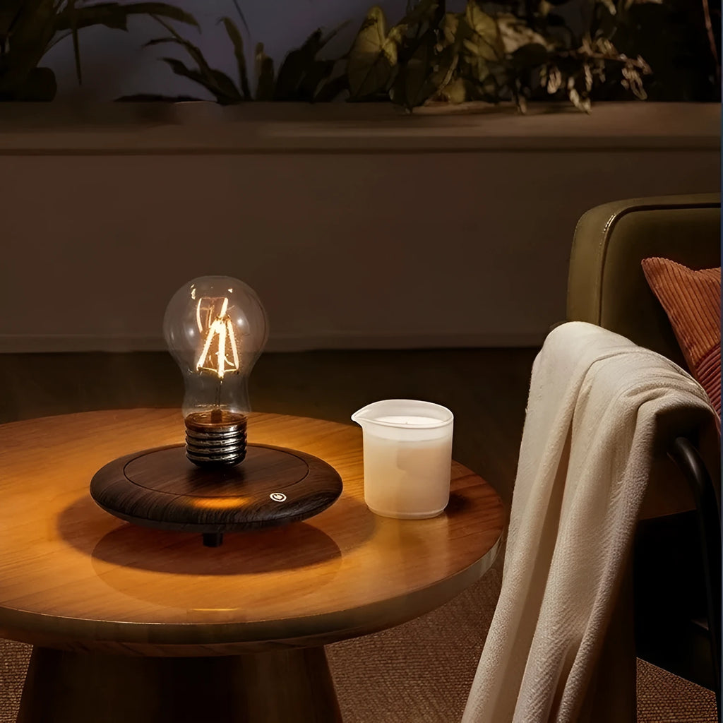 Iron art suspension bulb night lamp on a black wood grain desktop base.