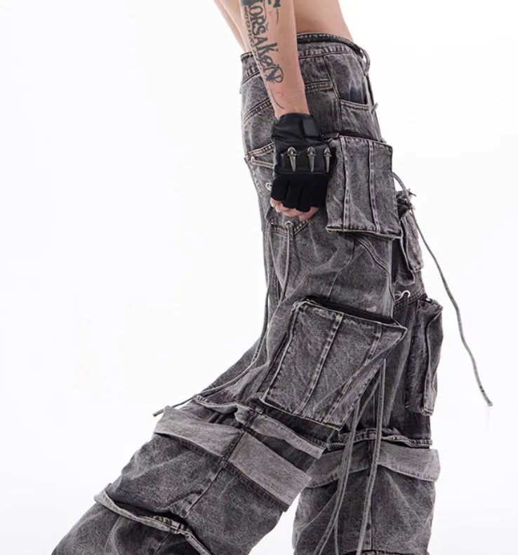 Grey cotton denim overalls with distressed finish and rope stitching on the legs.