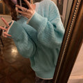 Women's loose pullover sweater in lake blue colour showing regular sleeves and solid colour design