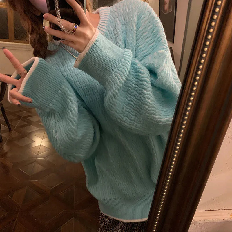 Women's loose pullover sweater in lake blue colour showing regular sleeves and solid colour design