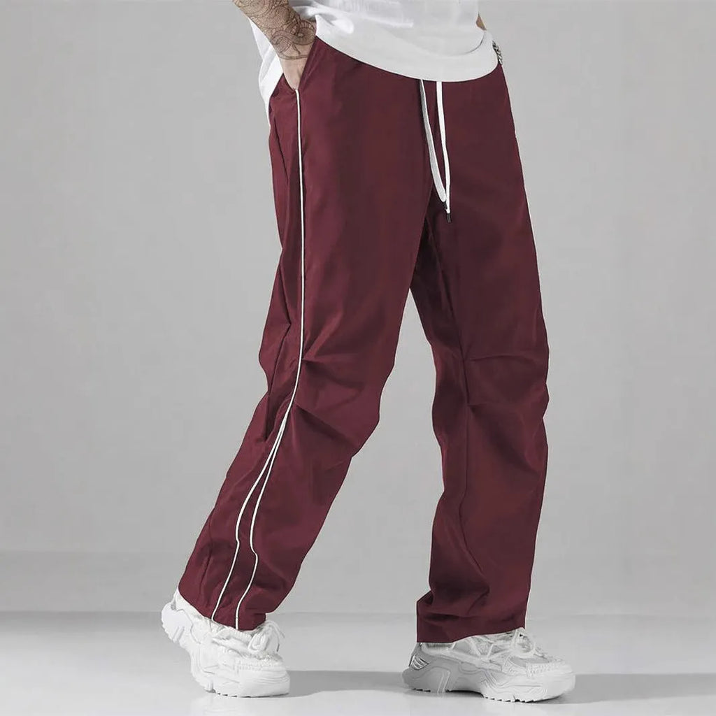 High street charging paratrooper pants for teenagers in straight leg style, available in multiple colours like black and dark green