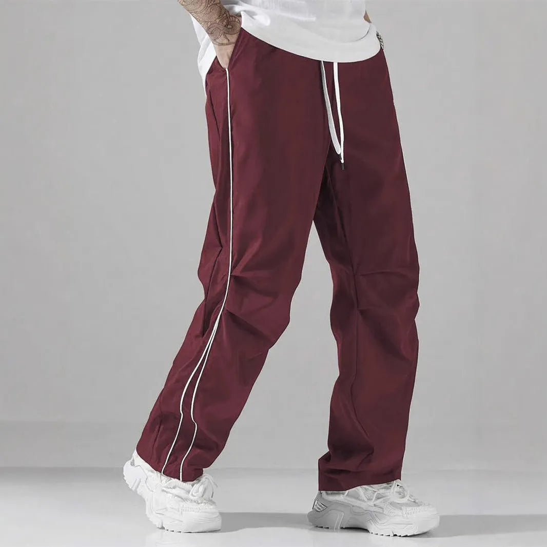 High street charging paratrooper pants for teenagers in straight leg style, available in multiple colours like black and dark green