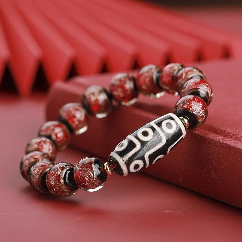 Close-up of a colourful handcrafted Chinese bracelet with snake lucky beads and auspicious patterns.