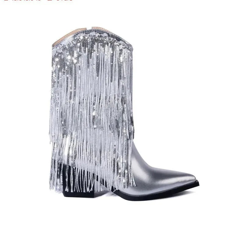 Women's black chunky heel tassel boots with pointed toe and high stiletto heel on a plain background.