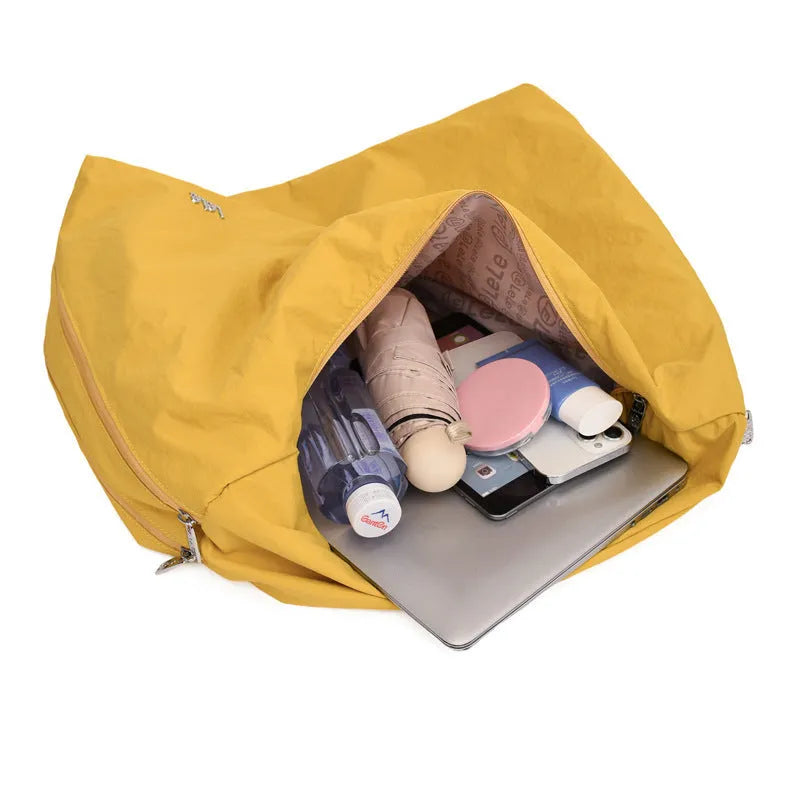 Nylon underarm bag in heart shape design showing large capacity, available in black, blue, khaki, and yellow colours