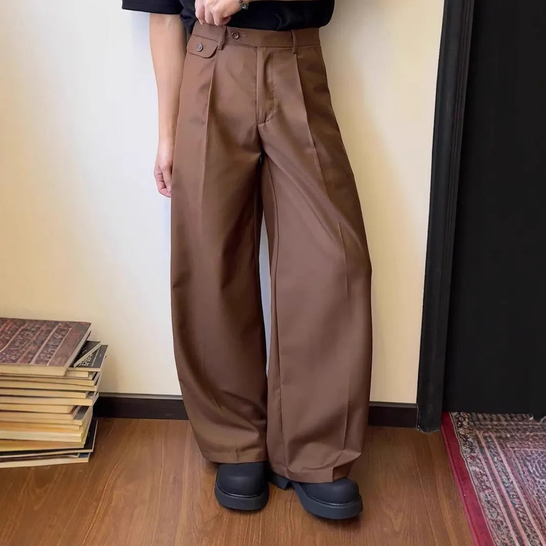 Men's straight-leg wide trousers in black, showing casual suit pant style with draping fabric.