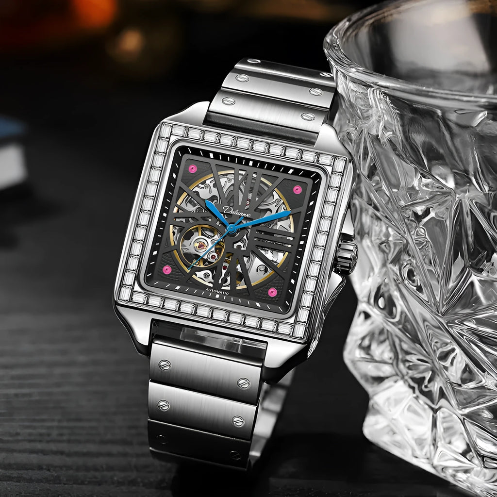 Men's square automatic watch with diamond-studded case on a black stainless steel bracelet.
