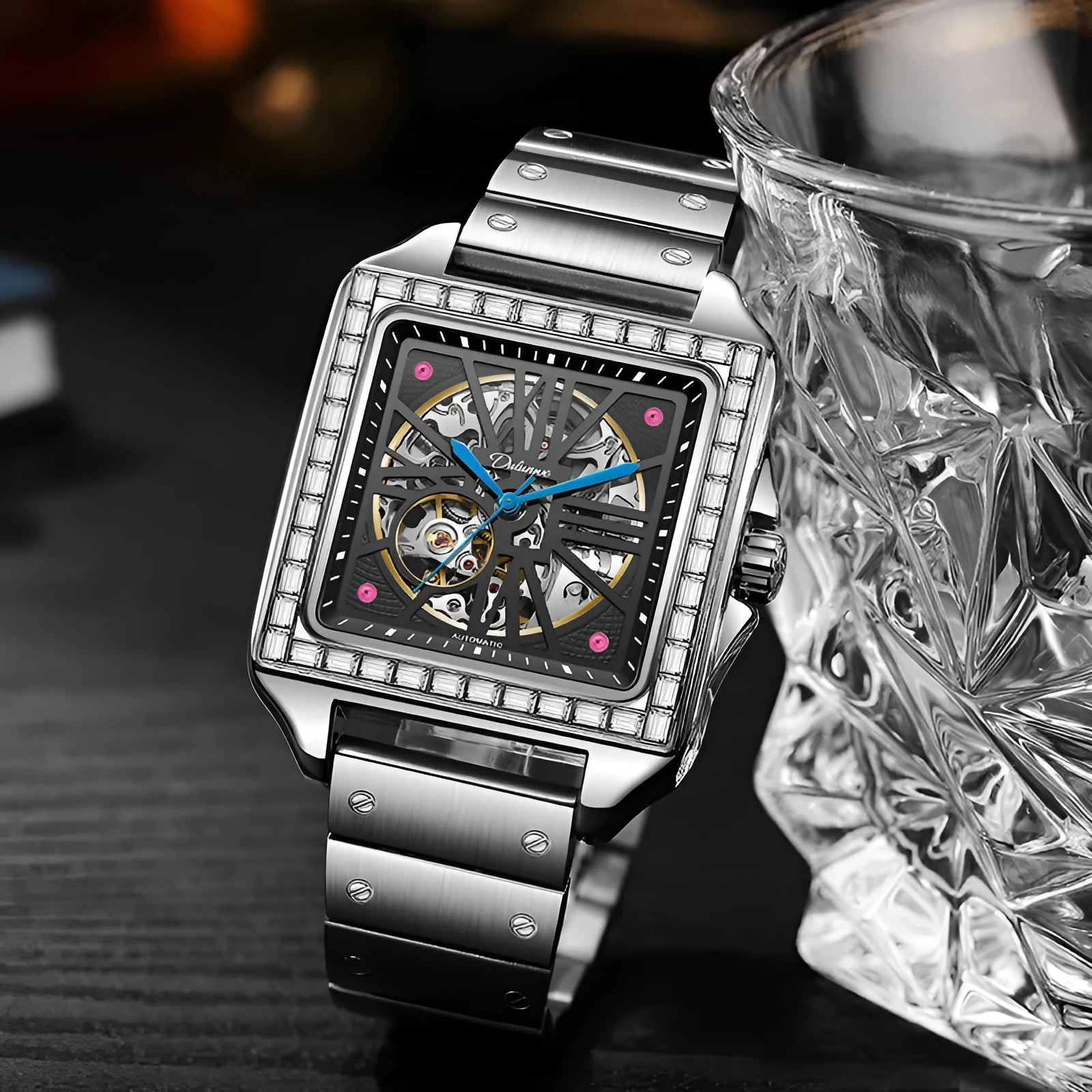Men's square automatic watch with diamond-studded case on a black stainless steel bracelet.