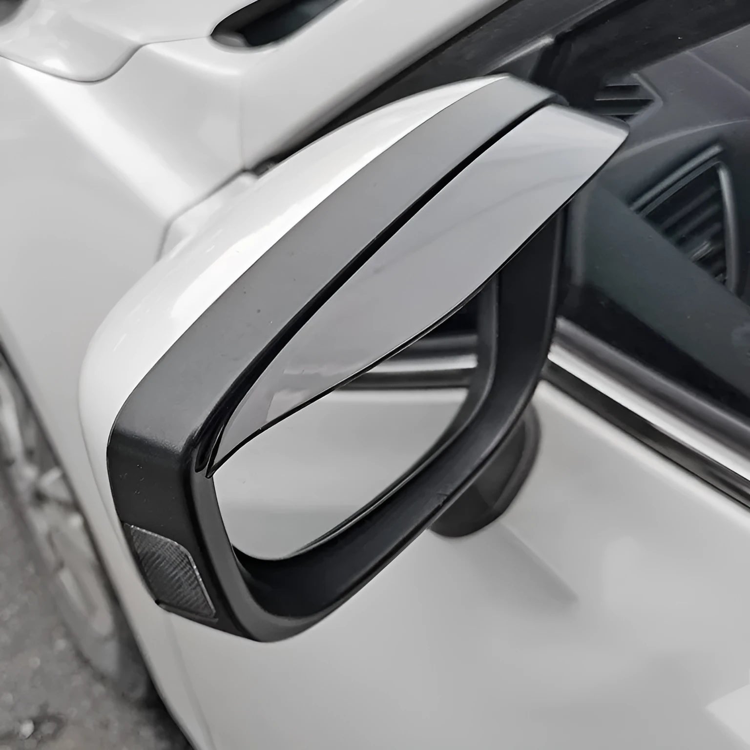 Pair of Mazda reversing mirror rain barrier strips in carbon fibre pattern on a Mazda CX5 side mirror