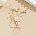 Gold-colour geometric earrings with a creative spiral and elliptical design for women.