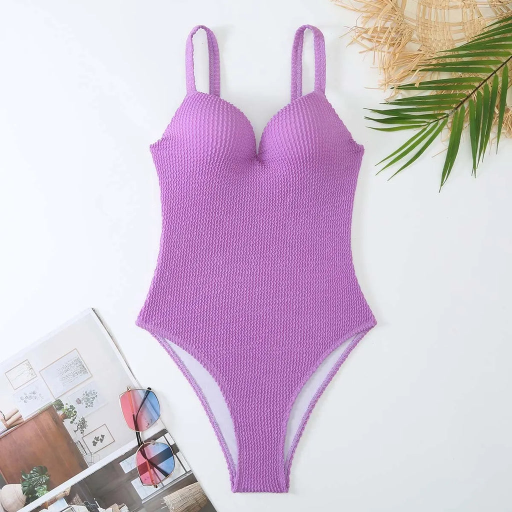 Women's black one-piece swimsuit with sunken stripe design and sleeveless cut on a mannequin.