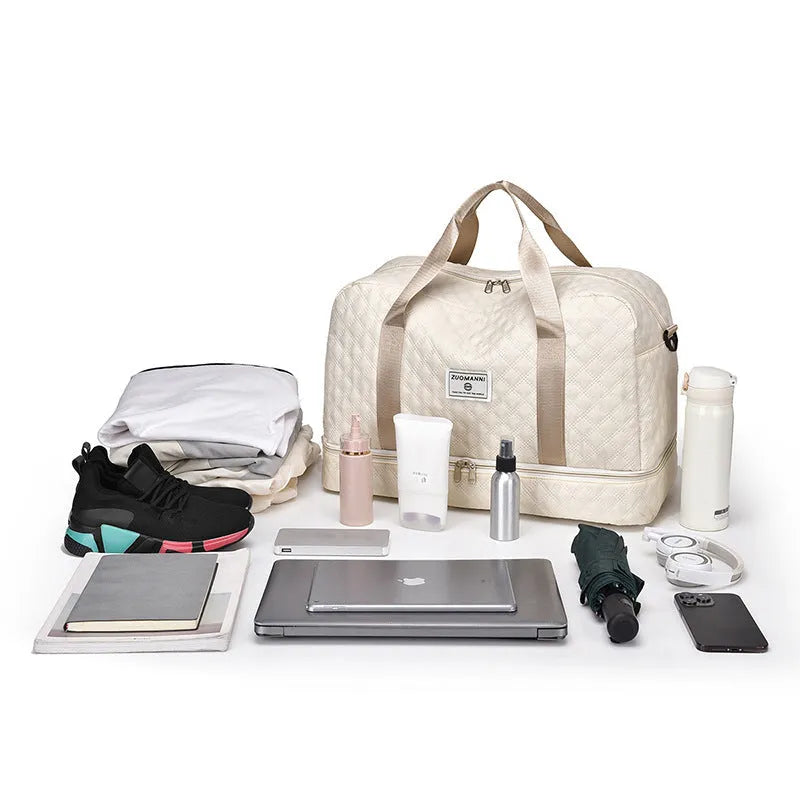 Large Oxford cloth travel bag in a solid colour with contrast stitching, shown with buggy and travel items.