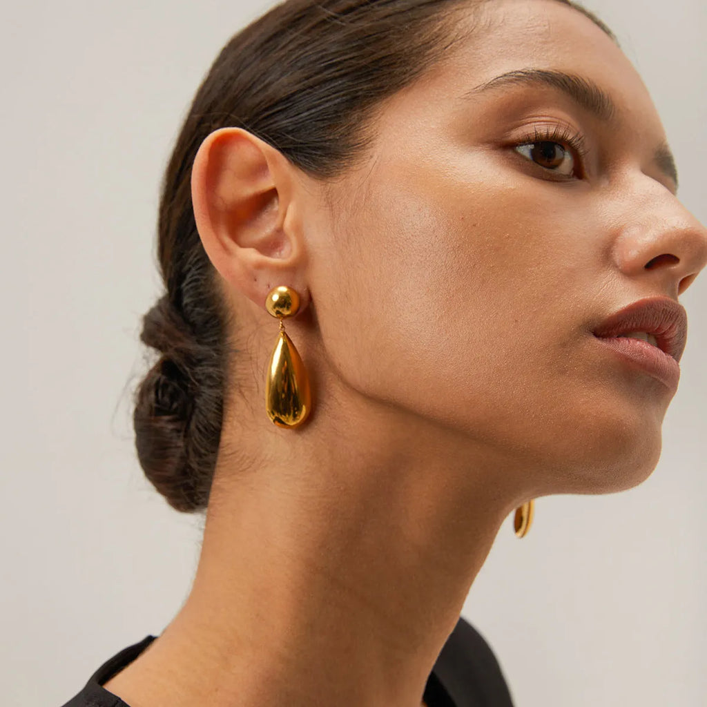 Gold electroplated stainless steel earrings with geometric hemisphere and water droplet pendant design