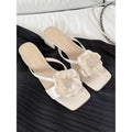 Women's cream satin sandals with a chunky block heel, square toe, and single cross-strap.