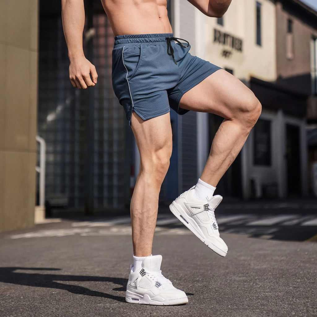 Man wearing straight-cut black polyester sports shorts for fitness or casual use.