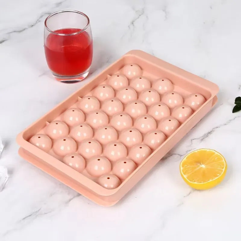 Blue round silicone ice cube tray with lid showing 33 large cavities, dimensions 24x14cm.