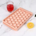 Blue round silicone ice cube tray with lid showing 33 large cavities, dimensions 24x14cm.