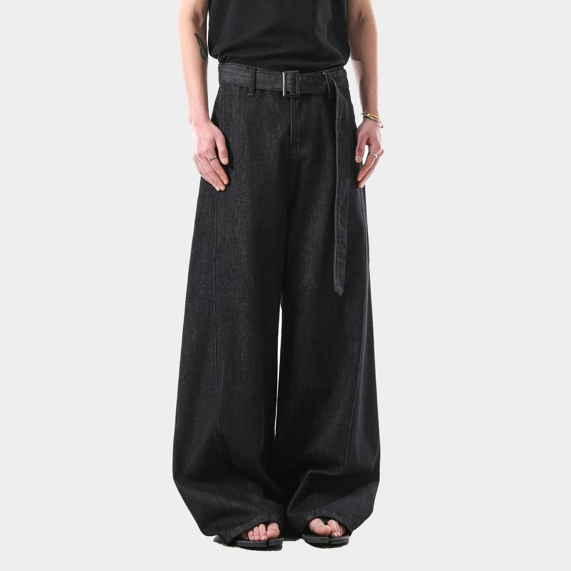 Black high waisted straight leg jeans with gold accents and zip fly opening