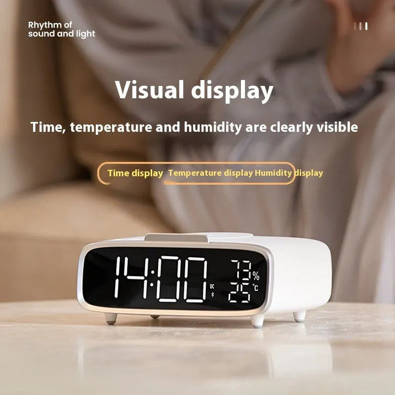 White wireless charging Bluetooth speaker alarm clock with night light on bedside table