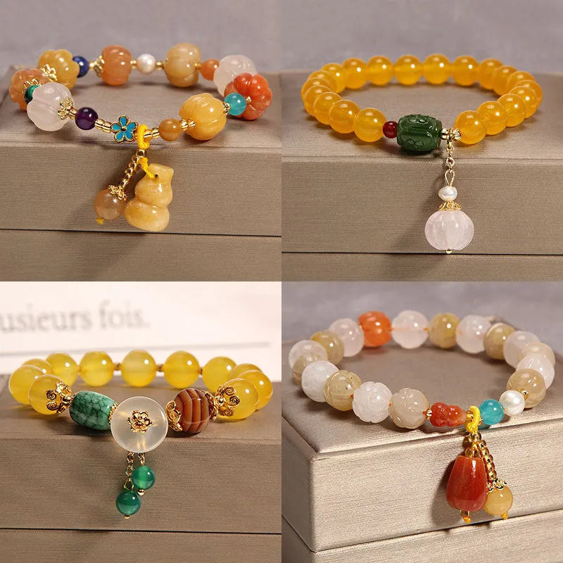 Women's khaki yellow agate crystal bracelet on a gold silk cord.