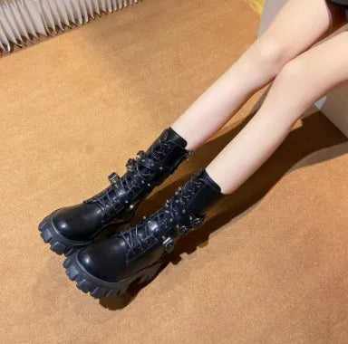 Black women's mid-calf boots with a large metal buckle and side zipper, featuring a round toe.