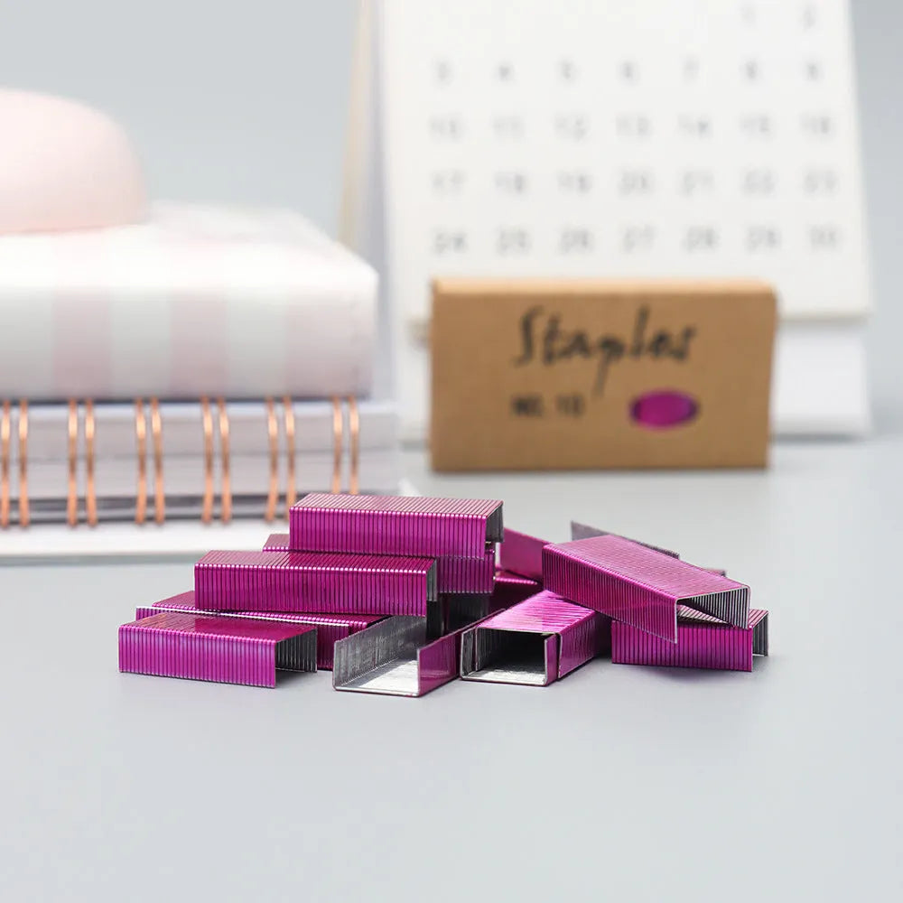 Box of 1000 metal office staples in rose gold, black, purple, and rose red colour options.