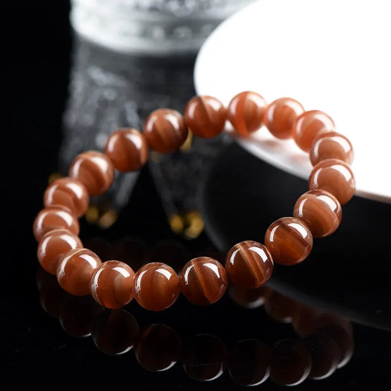 Natural Old Mine rhodochrosite mineral bracelet with round manganese spar beads in geometric design.