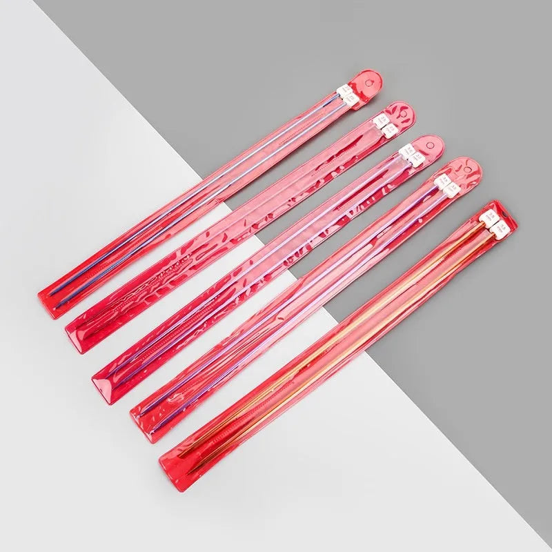 Complete set of aluminium crochet hooks in 14 sizes with protective caps laid out on a table.