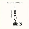 Black aluminium desk lamp on a table showing its three-colour dimming button and touch panel.