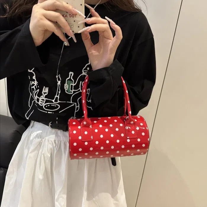 Korean-style cylindrical tote pillow bag in PU leather with stitched seams, black colour, single strap