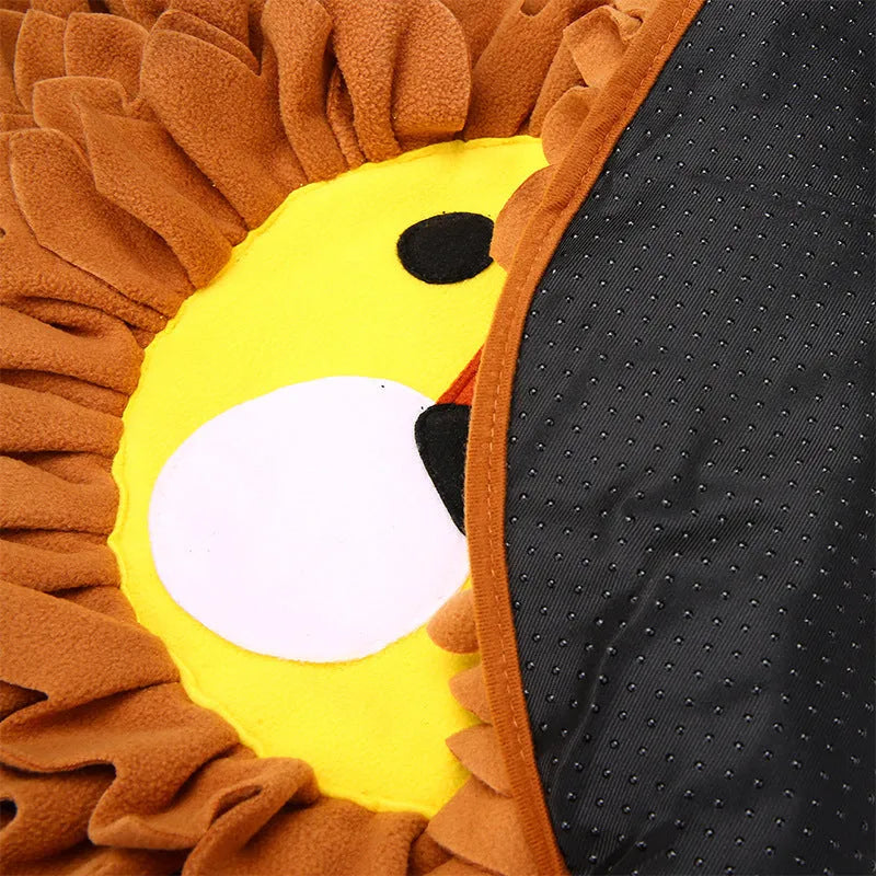 Brown lion-shaped sniffing pad pet toy for dogs and cats on a floor.