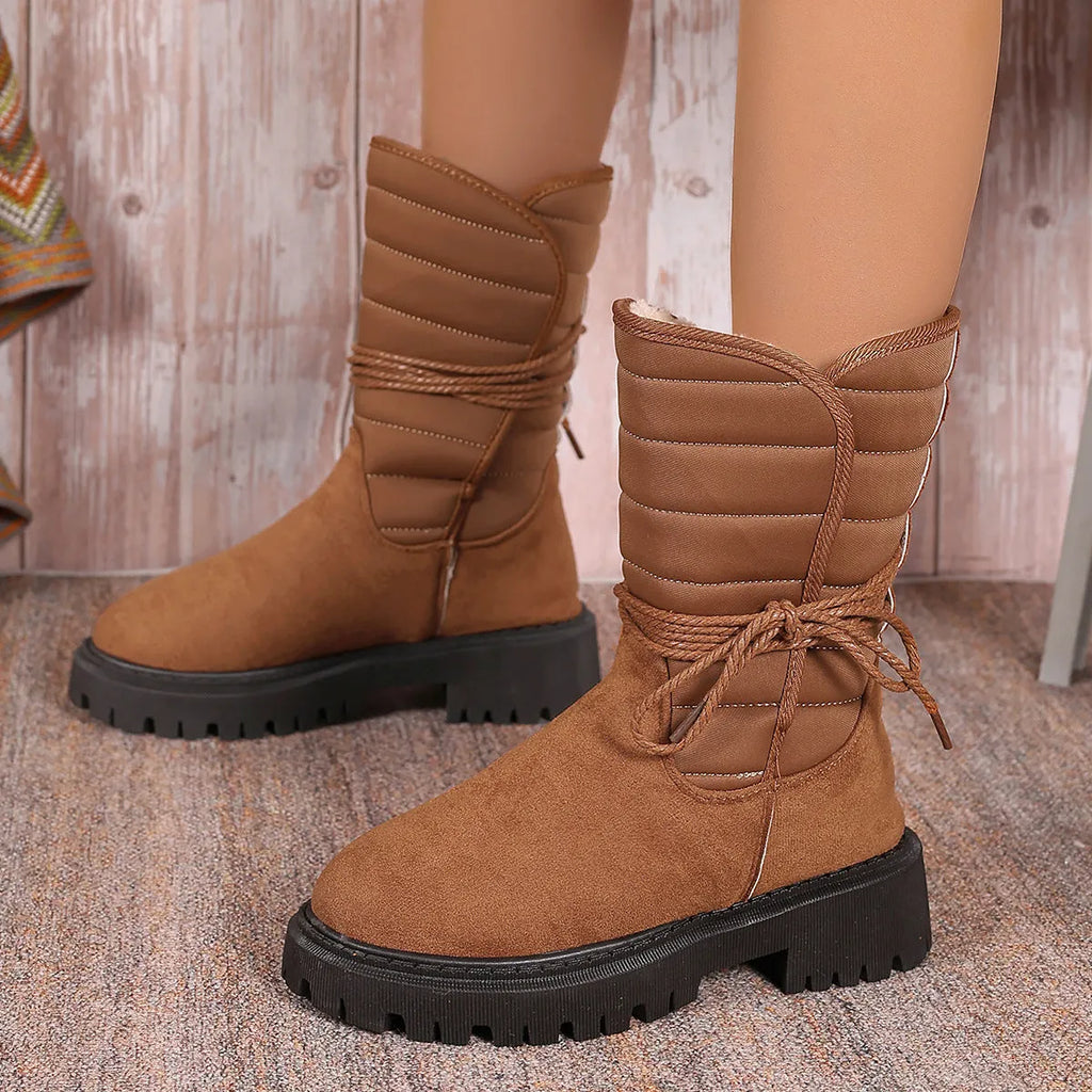 Women's black chunky heel snow boots with lace-up front and fleece lining on a white background.