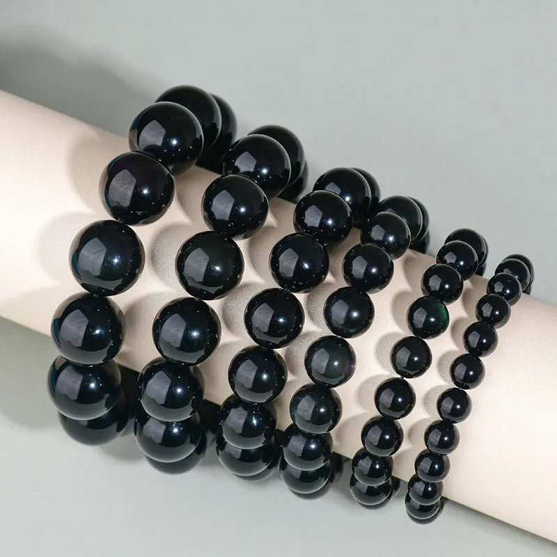 Hand-woven black obsidian bracelet showing round crystal beads in 8mm to 16mm diameter options with ethnic unisex styling