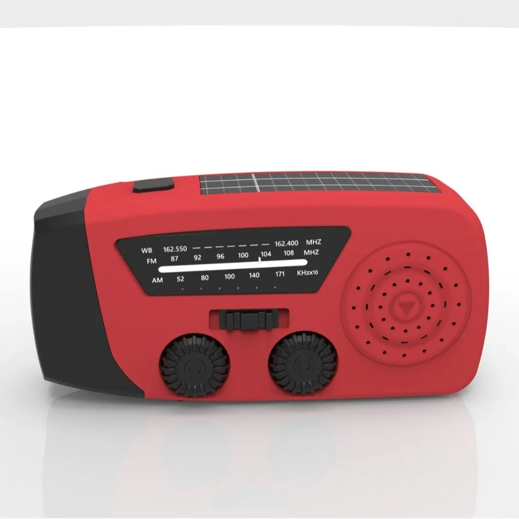 Red rechargeable emergency hand radio with torch, built-in speaker, USB port, and wrist strap.