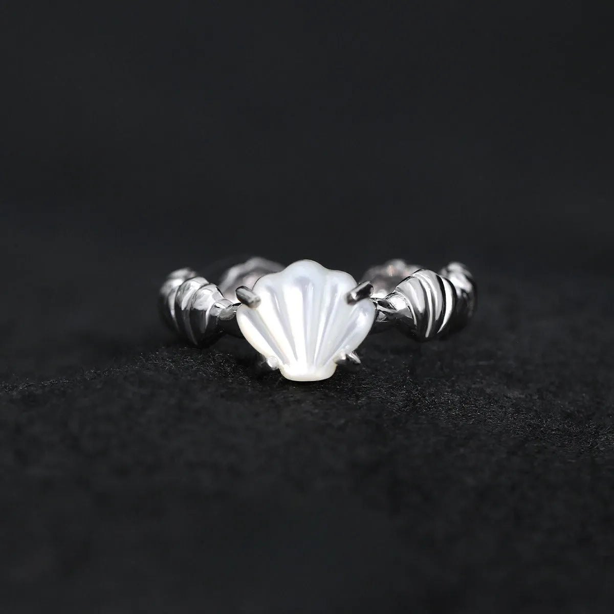 Women's sterling silver ring with shell element, tiger eye accents, and adjustable opening in gold electroplated finish