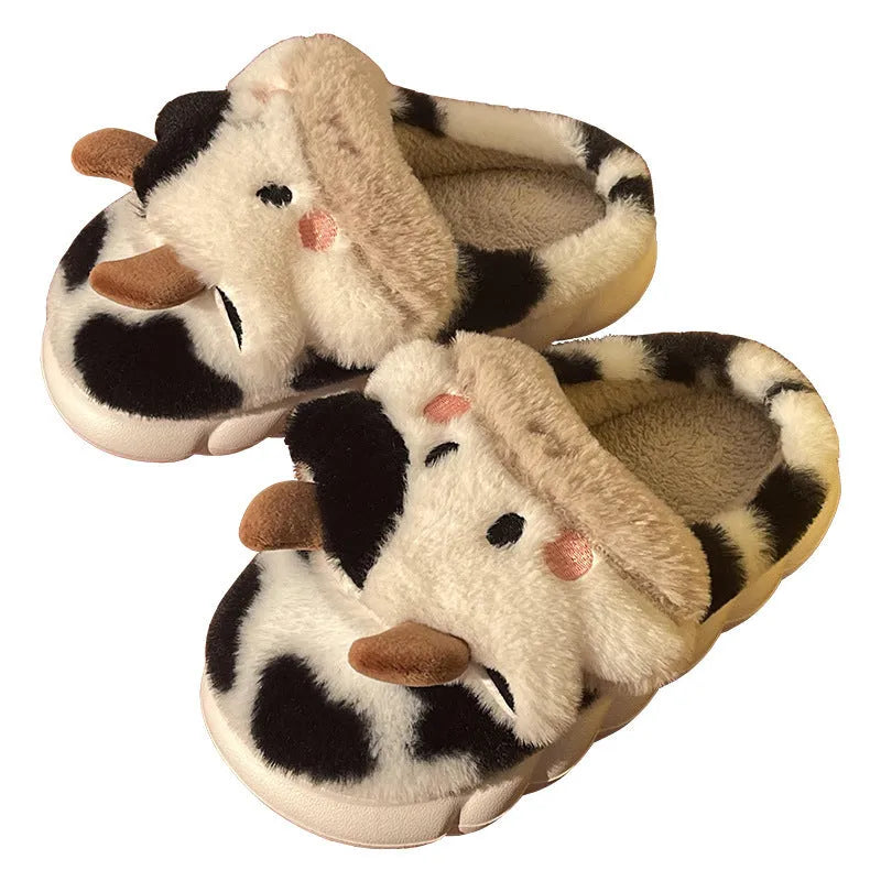 White plush cow-themed house slippers for women with a non-slip textured sole.
