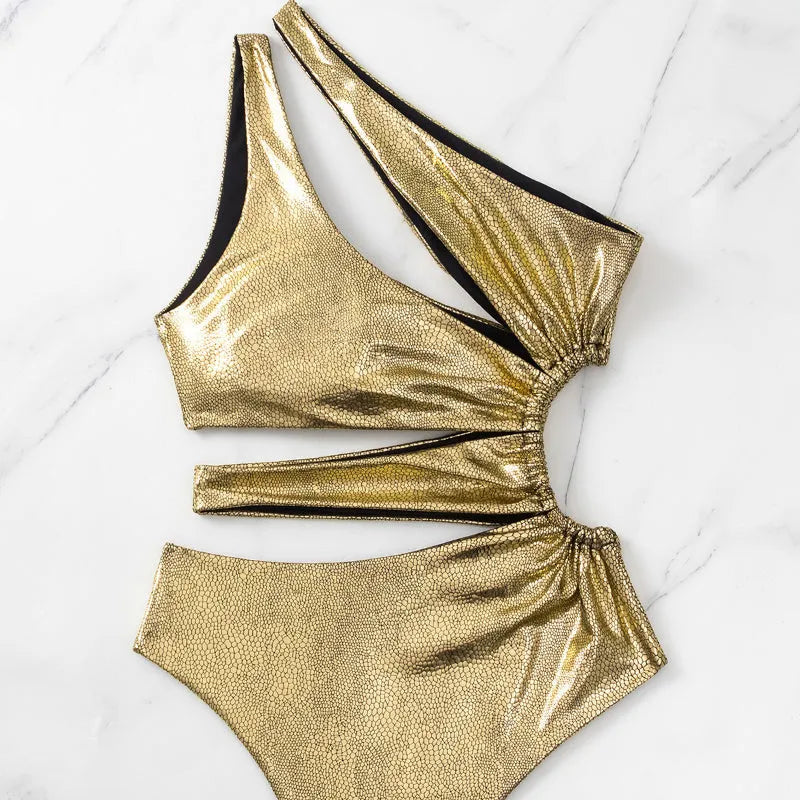 Women's gold one-piece swimsuit with backless design and high elasticity spandex construction.