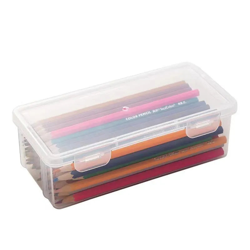 Clear plastic pencil storage box showing coloured pencils and drawing tools inside.