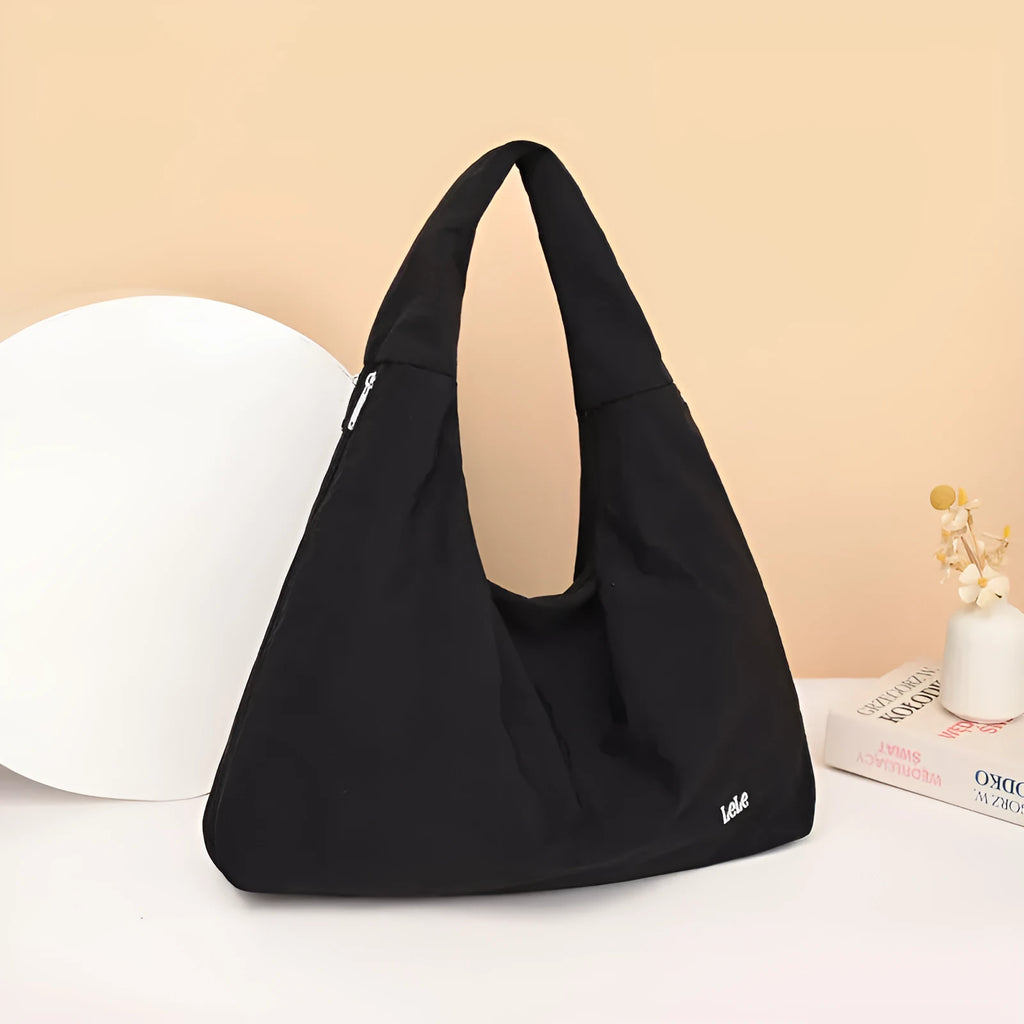 Nylon underarm bag in heart shape design showing large capacity, available in black, blue, khaki, and yellow colours
